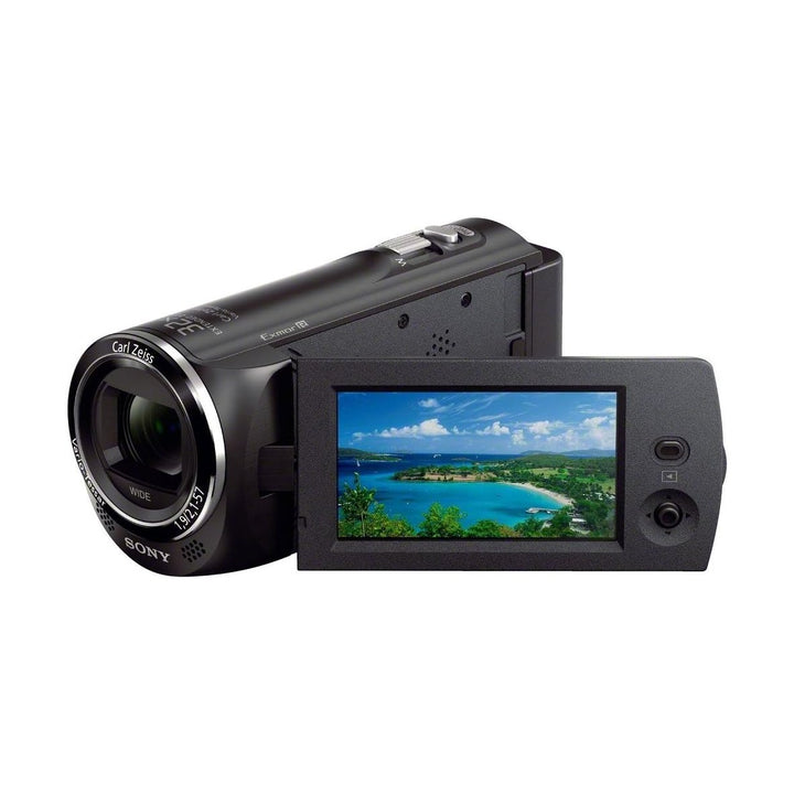 Sony HDR-CX230/B camcorder with downward angled screen displaying tropical island for vlogging at ClubCamera.com