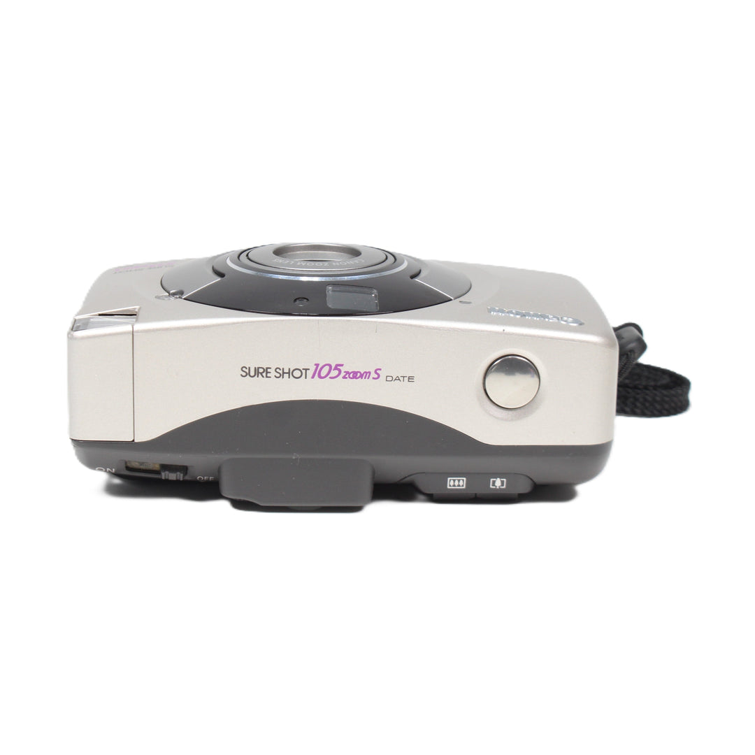 ClubCamera side profile of silver Canon Sure Shot 105 Zoom S showing ON/OFF switch and mode dial