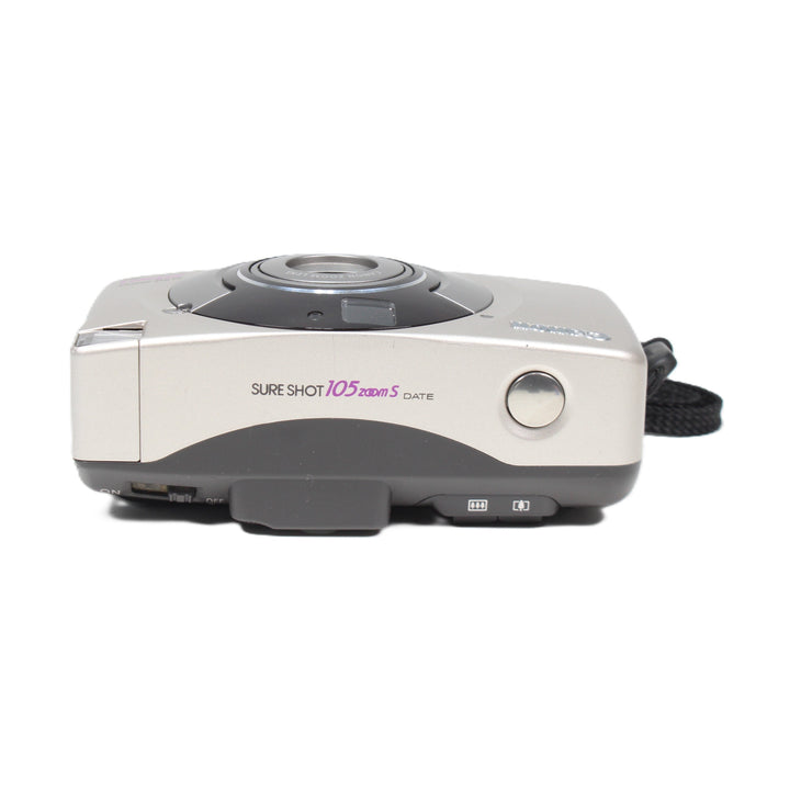 ClubCamera side profile of silver Canon Sure Shot 105 Zoom S showing ON/OFF switch and mode dial