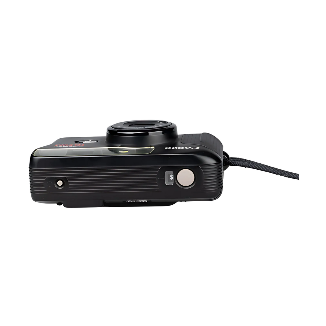 Side profile black Canon TELEMAX with beige shutter button, S mode dial, and glossy finish at ClubCamera.com