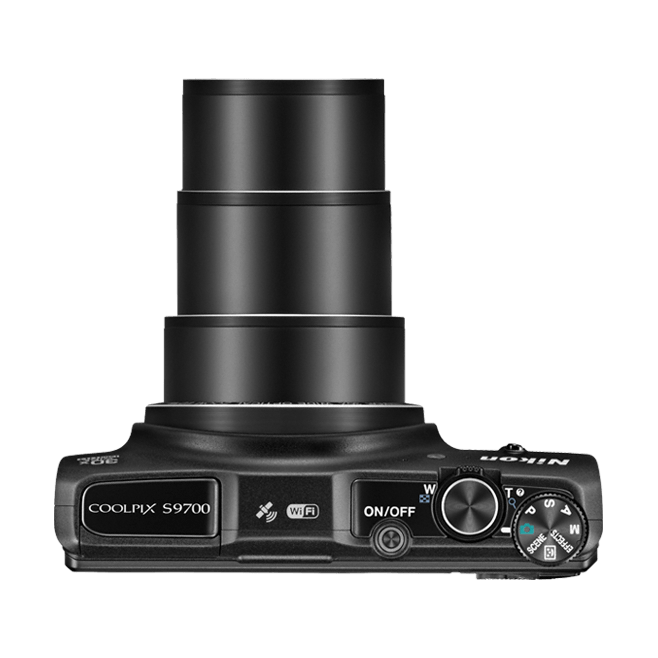Top-down view of black Nikon Coolpix S9700 with extended lens barrels and scene mode dial from ClubCamera.com