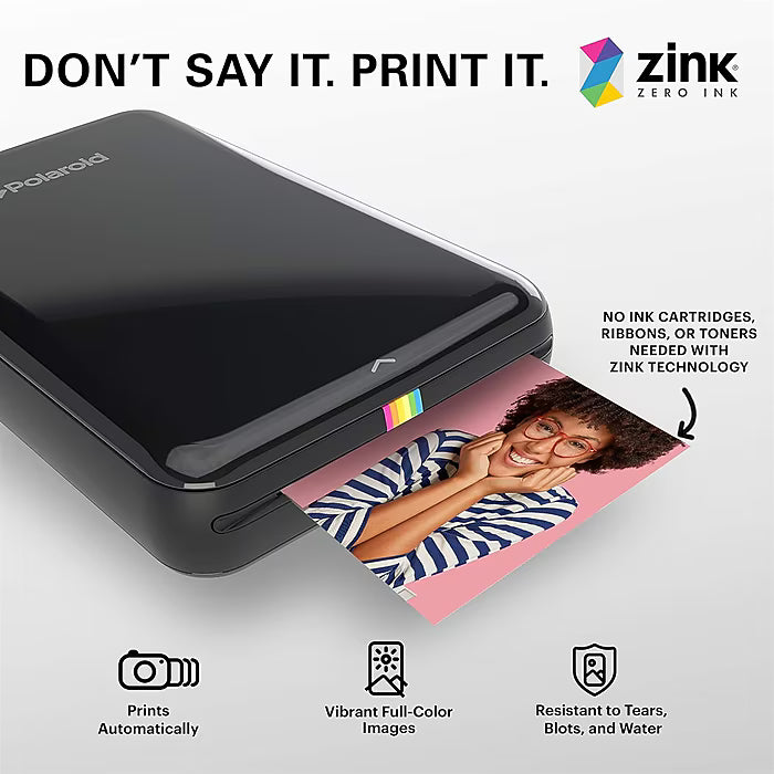 ClubCamera.com black Polaroid printer ejecting ZINK photo with rainbow indicator stripe and no ink cartridge technology overlay