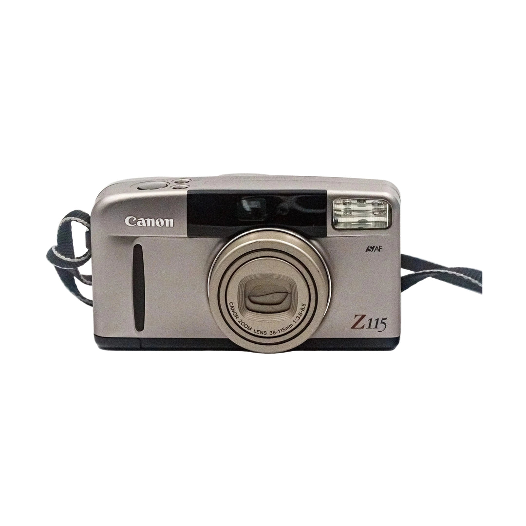 Frontal silver Canon Sure Shot Z115 35mm point and shoot film camera with retracted zoom lens and braided strap sold by ClubCamera.com