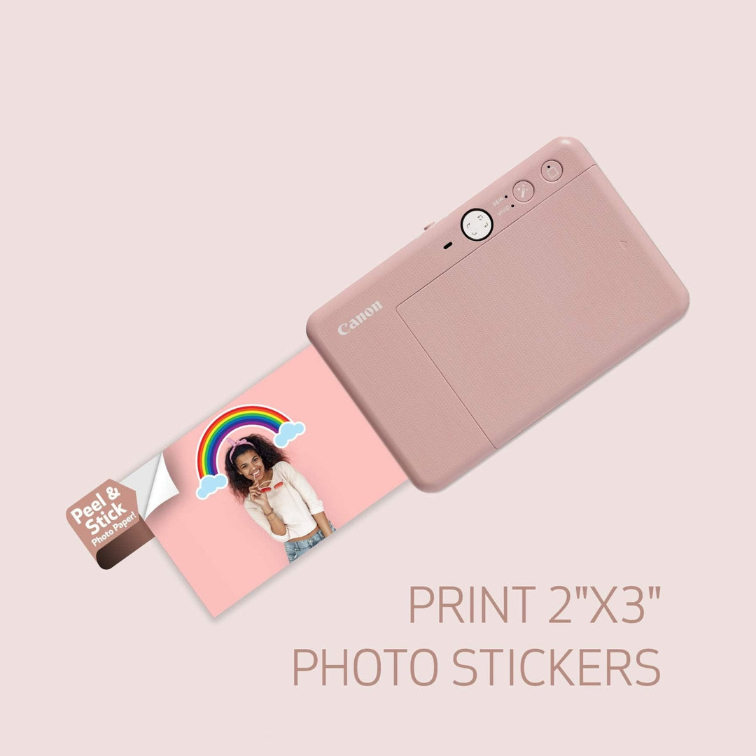 Rear view of rose gold Canon IVY CLIQ+2 printer ejecting 2x3 adhesive photo sticker at ClubCamera.com