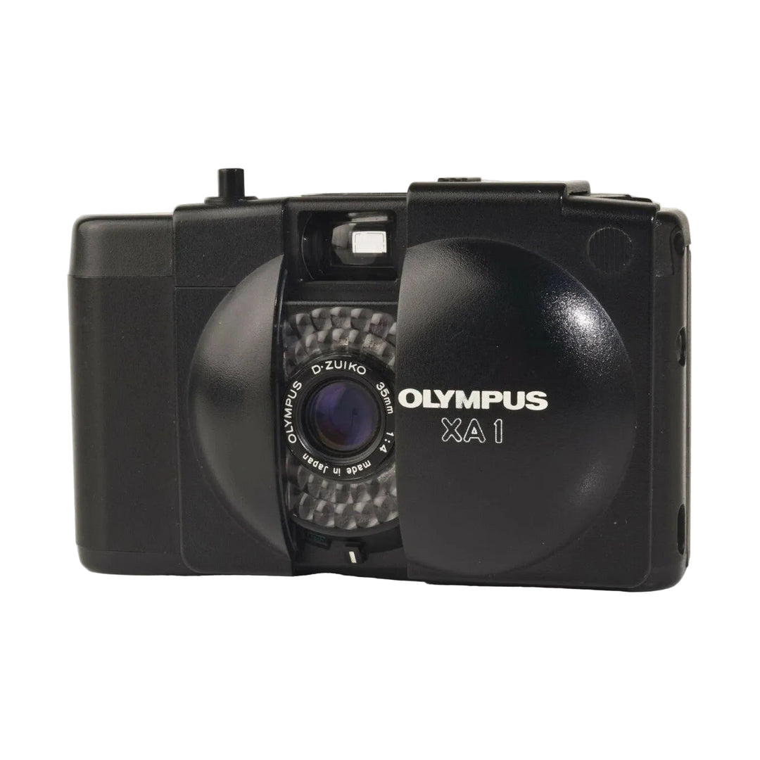 Front shot of black Olympus XA1 35mm film camera revealing D-Zuiko lens and white branding by ClubCamera.com