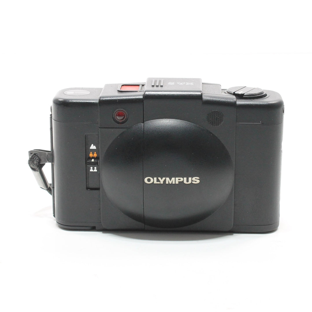 Black Olympus XA2 point-and-shoot film camera rear view with matte finish and wrist strap at ClubCamera.com