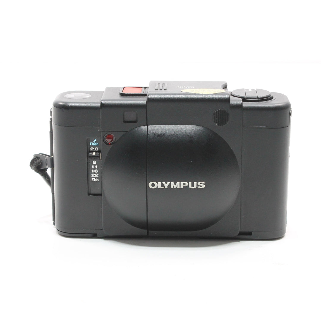 Black Olympus XA rear view with flash sync dial and silver logo at ClubCamera.com