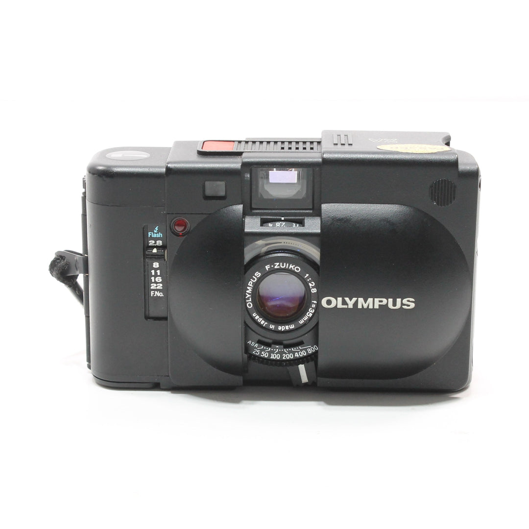 Front of black Olympus XA 35mm film camera with F-ZUIKO lens at ClubCamera.com