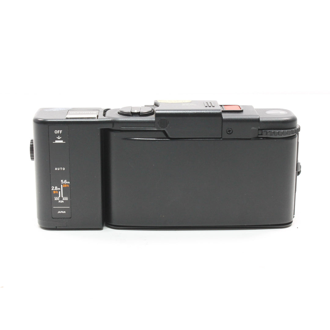 Rear view of slim black Olympus XA2 35mm film camera showing control panel labels and Japan origin at ClubCamera.com