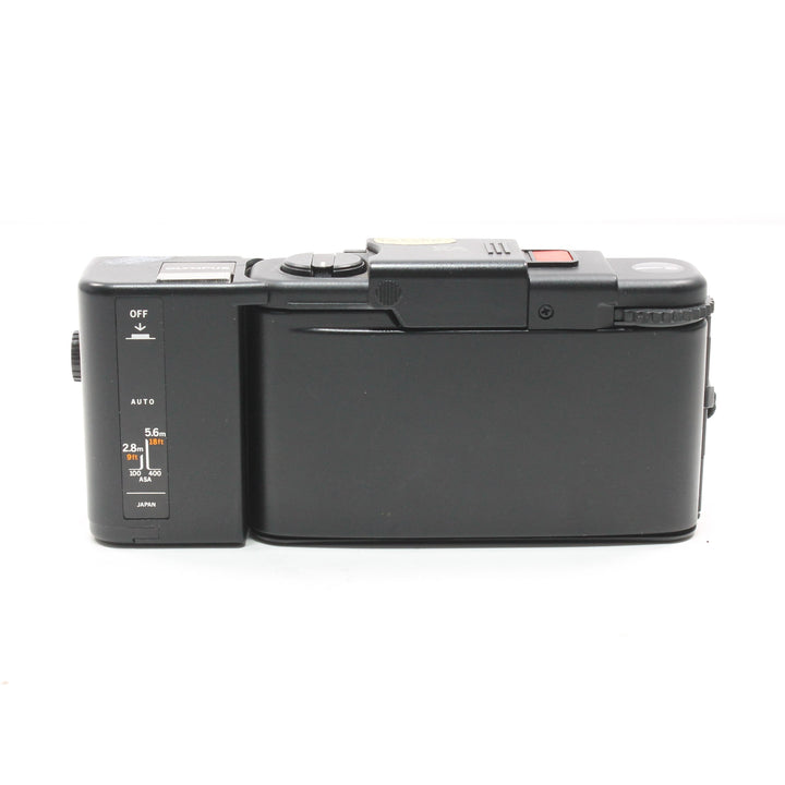 Rear view of slim black Olympus XA2 35mm film camera showing control panel labels and Japan origin at ClubCamera.com