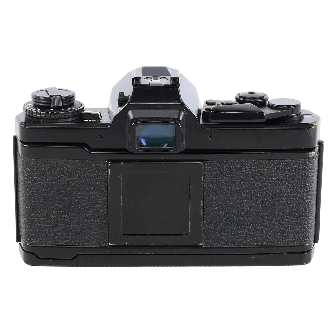 Rear top view of vintage black Olympus OM-4 SLR camera showing leatherette back panel and mode dial at ClubCamera.com