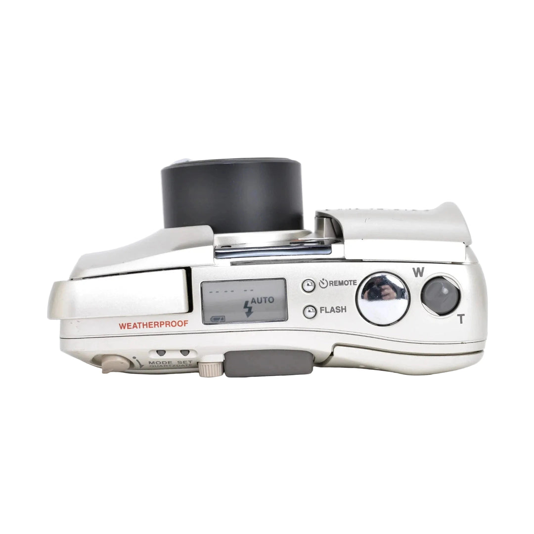 Silver Olympus Stylus Zoom 105 film camera side profile with weatherproof text and zoom lever at ClubCamera.com
