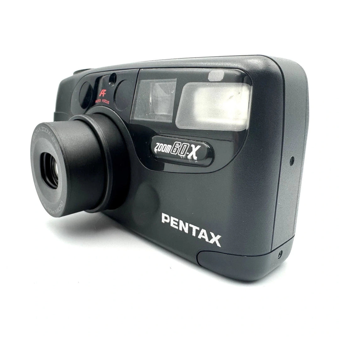 Pentax IQZoom 60X black compact 35mm film camera front-left profile with zoom lens and textured grip from ClubCamera.com