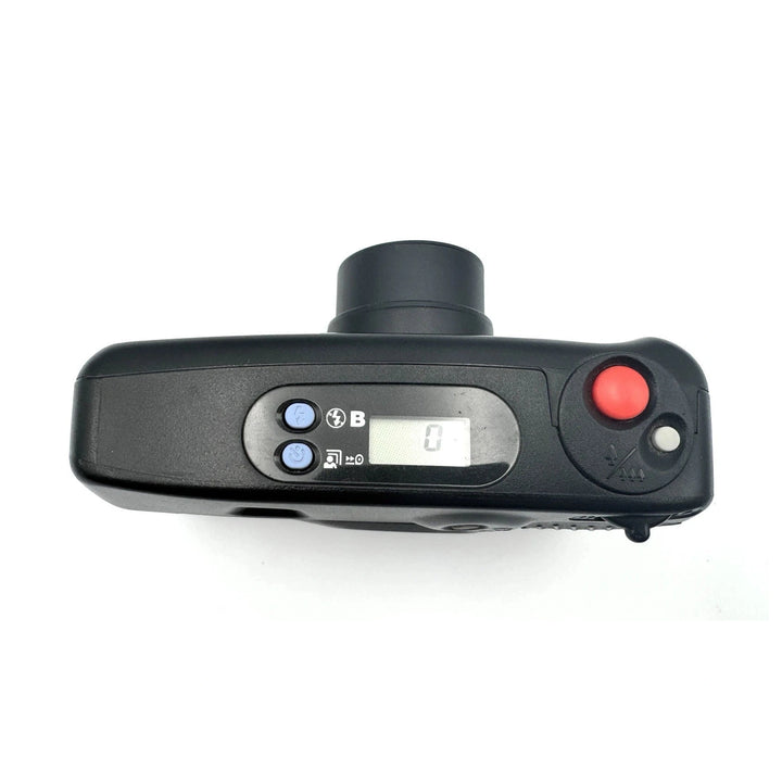 Top view of Pentax IQZoom 60X black 35mm point-and-shoot showing LCD display, blue function buttons, and shutter release from ClubCamera.com