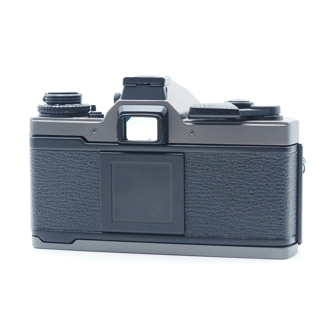 Black Olympus OM-3ti rear view showing textured grip and mechanical shutter release from ClubCamera.com