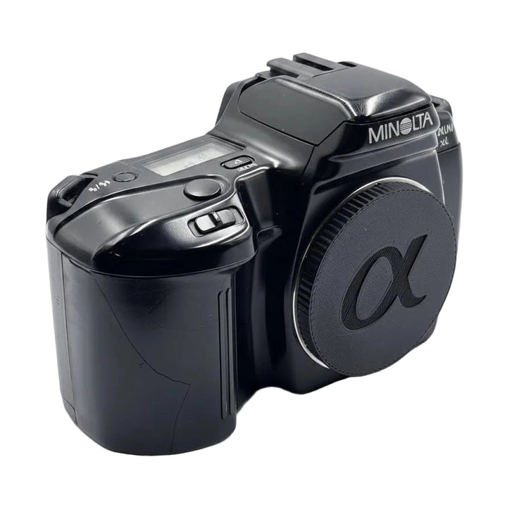 Left side view of Minolta Maxxum 3xi black autofocus SLR showing mode dial and grip texture from ClubCamera.com