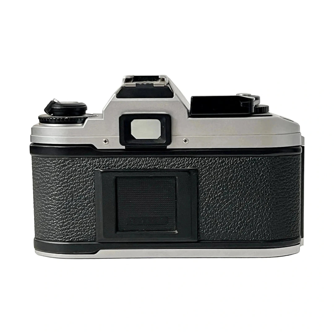 Rear view of textured black leatherette grip on silver aluminum Nikon FG-20 35mm film SLR body with rewind crank and advance lever from ClubCamera.com