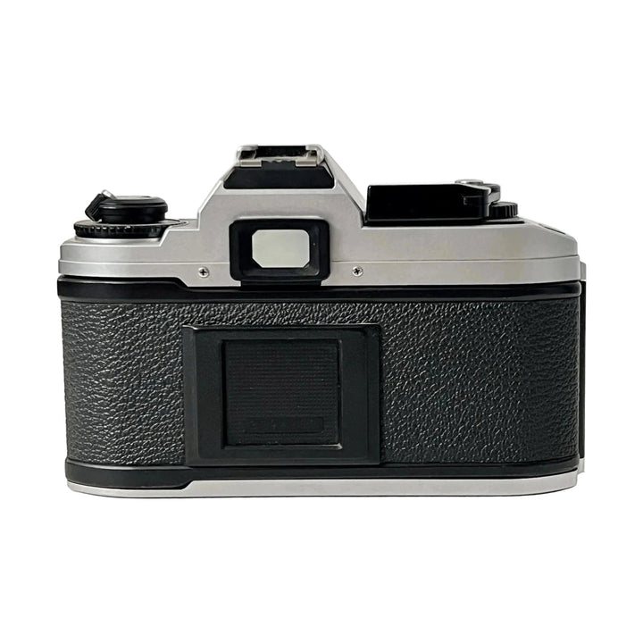 Rear view of textured black leatherette grip on silver aluminum Nikon FG-20 35mm film SLR body with rewind crank and advance lever from ClubCamera.com