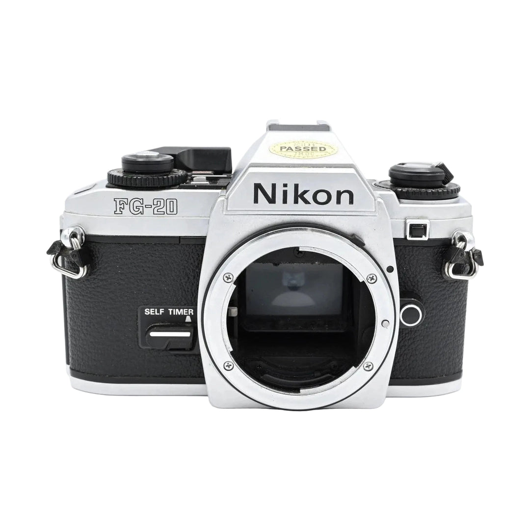Nikon FG-20 silver and black SLR film camera body with exposed lens mount, textured grip, and PASSED IMOC sticker at ClubCamera.com