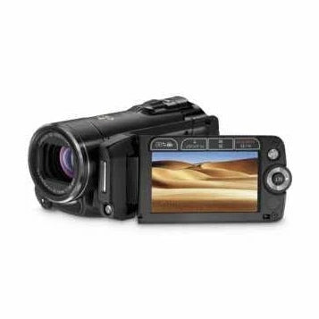 Black Canon VIXIA HF20 HD camcorder by ClubCamera.com with flip-out LCD showing desert dunes and 15x optical zoom