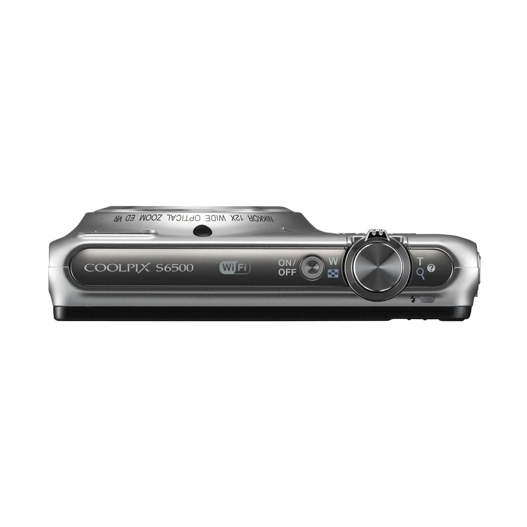 Top-down silver Nikon Coolpix S6500 with Wi-Fi logo, mode dial, and power switch visible on ClubCamera.com