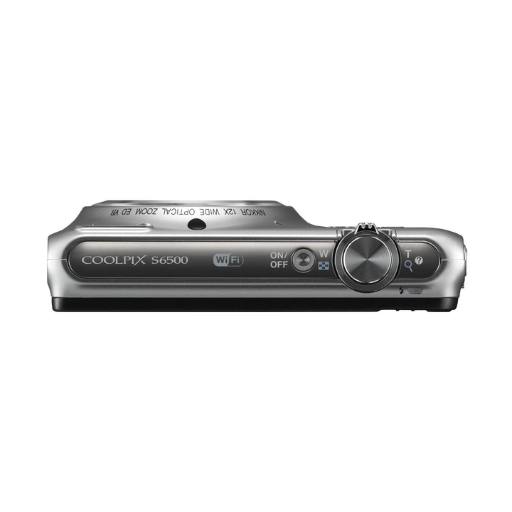Top-down silver Nikon Coolpix S6500 with Wi-Fi logo, mode dial, and power switch visible on ClubCamera.com