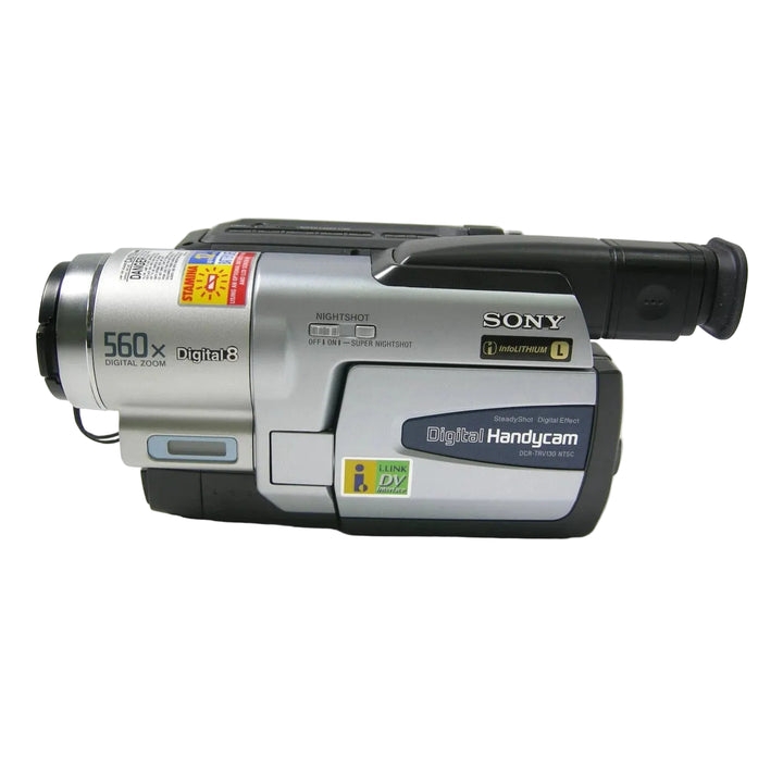 ClubCamera.com silver and black Sony DCR-TRV130 Handycam front view showing 560x digital zoom lens and NightShot switch